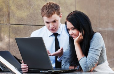 Young couple with laptop.